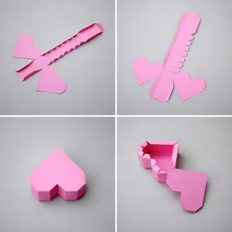 กระดาษหัวใจด้วยมือของตัวเองบนผนังในเทคนิค Origami