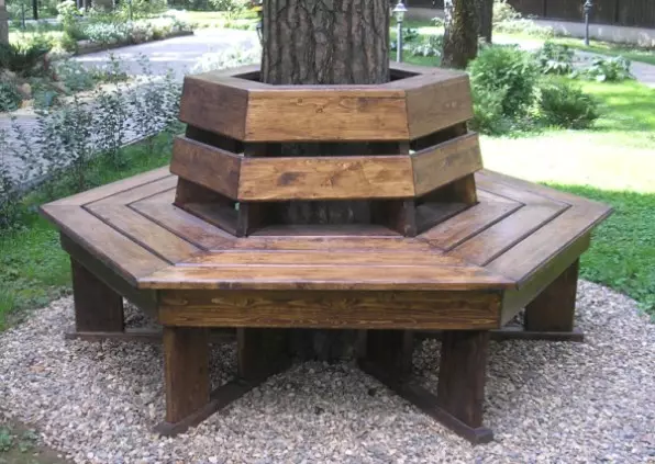 Arrangement around the tree: flowerbed, bench, table and even gazebo