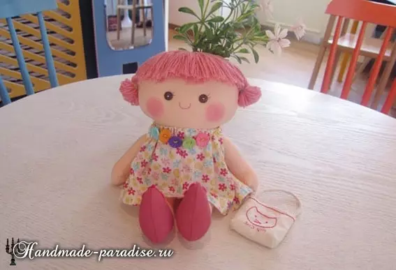 Textile doll priming with their own hands